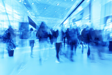 blue background blurred movement of people shopping mall