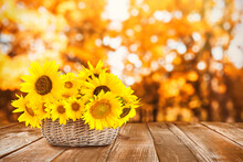 Bouquet Of Beautiful Yellow Sunflowers In Wicker Basket On Wooden Table, Space For Text