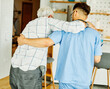 nurse doctor senior care caregiver help assistence retirement home nursing helping holding hug elderly man woman health support walking cane stick
