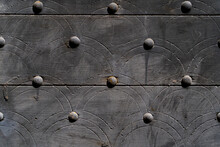 Wooden Door With Metal Round Buttons.