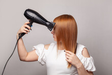 Stylish Model Woman With Hair Dryer On Gray Wall Studio Background