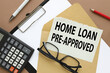 Home loan pre approval. text on torn white paper on envelope bright stickers. clip folder.
