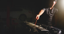 Mechanic Hand Is Pulling Dipstick Of The Car Engine For Checking Motor Oil Level And Auto Repair Shop Double Exposure Blur On Background