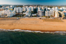 Aerial View Of Beach, Boardwalk And Buildings In Quarteira, Algarve, Portugal