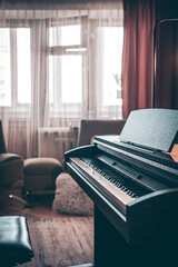 Wall Mural - Electronic piano in the interior of the room on a blurred background.