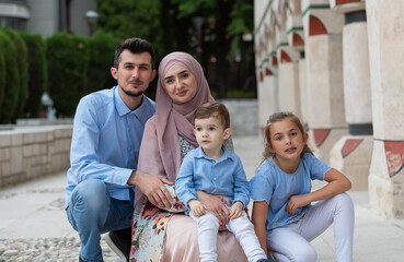 Wall Mural - Portrait of a happy young Muslim family outdoor.