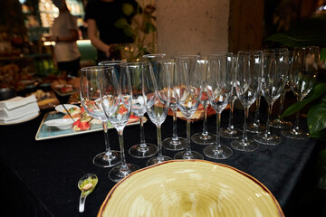 at the served table, glasses and dishes on the table 