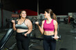 © AntonioDiaz - Smiling personal trainer and fat woman exercising