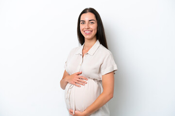 Wall Mural - Young caucasian woman isolated on white background pregnant and happy