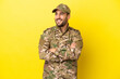 Military man isolated on yellow background happy and smiling
