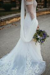 Wall Mural - Happy beautiful bride holding wedding bouquet.