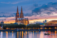 View Of The Hohenzollern Bridge Over The Rhine River And The Iconic Cathedral Of Cologne - UNESCO World Heritage Site Since 1996