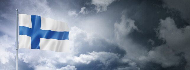 Wall Mural - Finnish flag on a cloudy sky