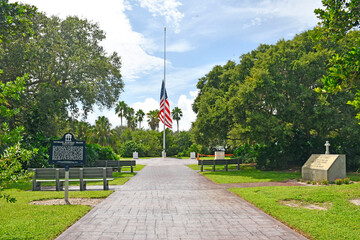 Wall Mural - Flag at half mast at the Veterans Memorial Island Sanctuary in Vero Beach, Florida.