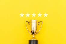 Simply Flat Lay Design Winner Or Champion Gold Trophy Cup And 5 Stars Rating Isolated On Pink Pastel Background. Victory First Place Of Competition. Winning Or Success Concept. Top View Copy Space.