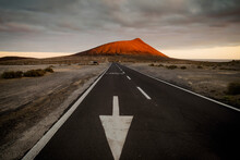 Straight Road Leading To Red Mountain (Montana Roja) At Sunset, El Medano, Tenerife, Canary Islands, Spain