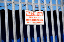 CCTV Warning Being Monitored Sign And Spiked Barbed Wire Fence