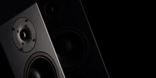 Stereo Sound Speakers Closeup On Black Background With Copy Space. Contrast, Accent Lighting From The Side
