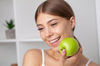 © Maksymiv Iurii - Beautiful woman with healthy white teeth holding green apple