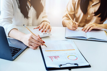 Negotiation, Analysis, Discussion, Asian woman economist and marketer pointing to a financial data sheet to plan investments to prevent risks and losses for the company