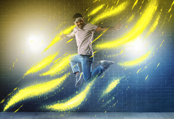 Wall Mural - Handsome man dancing hip-hop in studio