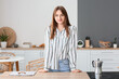 © Pixel-Shot - Pretty young woman near counter in kitchen