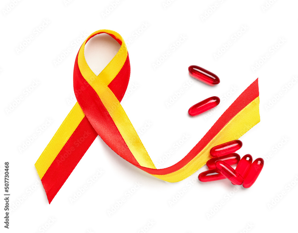 Awareness ribbon and pills on white background. Hepatitis concept