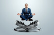 © Aliaksandr Marko - A businessman in the lotus position levitates over a bear trap. Concept of problem solving, failure, crisis, crisis management mixed media.