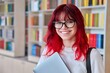 Portrait of female college student in glasses with laptop backpack, looking at camera