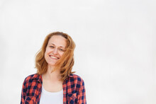 Happy Woman Wearing Plaid Shirt Standing Against White Background