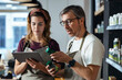 © Westend61 - Store owners checking inventories at organic market