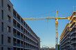 © Westend61 - Germany, Bavaria, Munich, Construction site in Prinz-Eugen-Park complex with industrial crane standing in background