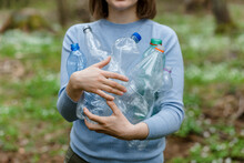 Woman Carrying Plastic Bottles Collected In Forest