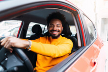 Smiling Afro Man Sitting On Driver's Seat