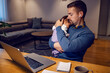 © Dusan Petkovic - A caring father and entrepreneur cuddling his daughter on a break with his online job from home.