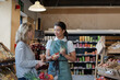 © ReeldealHD images - Sales assistant helping customer in a grocery store