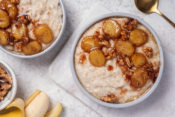 Wall Mural - Porridge with caramelised banana and walnut for healthy breakfast