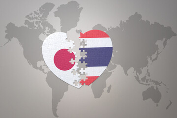 Wall Mural - puzzle heart with the national flag of japan and thailand on a world map background. Concept. 3D illustration