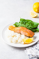 Canvas Print - Fried salmon with rice and spinach on white plate. Diet recipe concept.