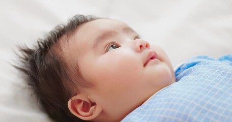 Poster - baby lying on the bed