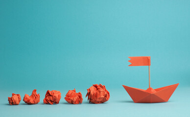 New ideas or transformation concept with crumpled paper balls and a boat, transformation or teamwork concept, creativity, make a change
