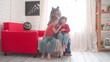 Children with their mother decorate the room for Halloween