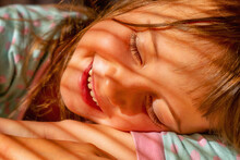 Happiness, Carelessness And A Sense Of Absolute Safety. Young Child Girl Sleping In Morning Sun Rays. Horizontal Image.