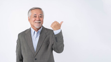 Asian senior businessman , old man with suit feel happy good health pointing finger to empty copy space for present product or blank space for advertising isolated on white background