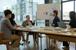 © amnaj - Meeting of Asian business people who are committed to work. Creative business team sitting working together at office.