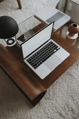 Wall Mural - Laptop computer with blank screen on wooden table with lamp. Aesthetic influencer styled workspace interior design template with mockup copy space