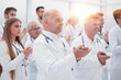 © ASDF - large group of medical practitioners applauding together.