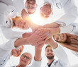 © ASDF - close up. group of different doctors putting their hands together