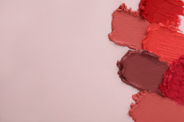 Sticker - Smears of different beautiful lipsticks on light background, top view. Space for text