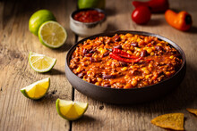 Mexican Hot Chili Con Carne In A Bowl With Tortilla Chips On Wooden Background